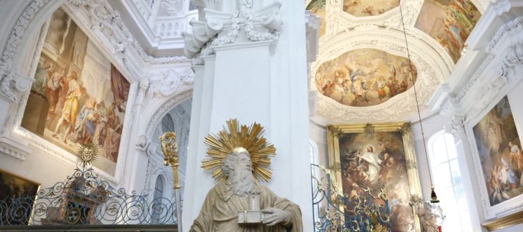 Altarraum mit weißem Stuck, Fresken, Altarbild und Statue des heiligen Benedikt