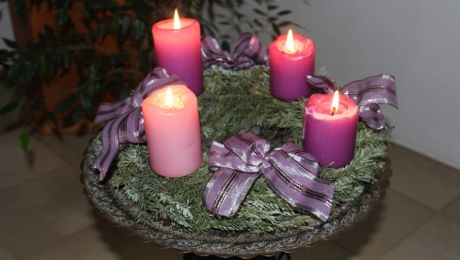 Adventkranz mit vier brennenden Kerzen